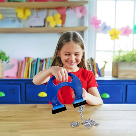 Young girl playing with a blue 4M KidzLabs Giant horseshoe magnet in a classroom setting.