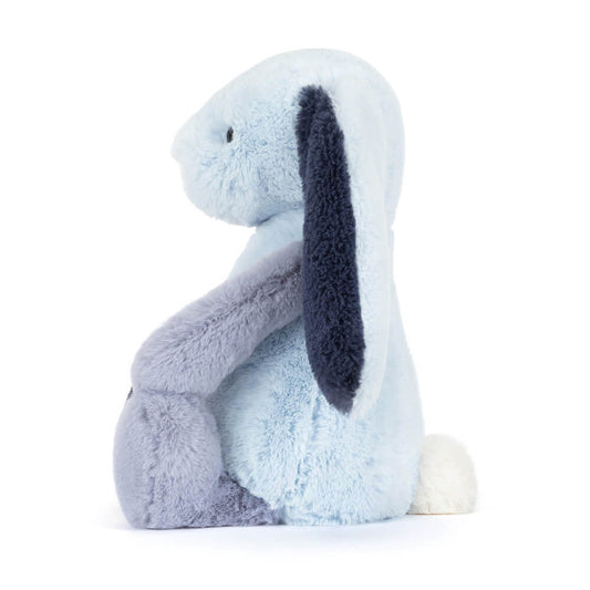 Geometric light and dark blue bunny toy against a white background, side view