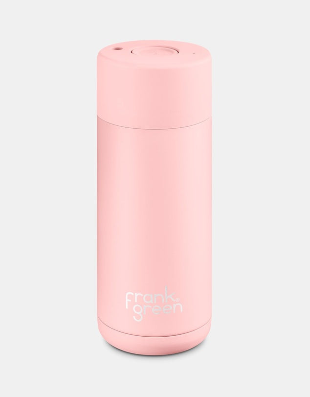 Pink reusable water bottle with 'frank green' branding on a light gray background