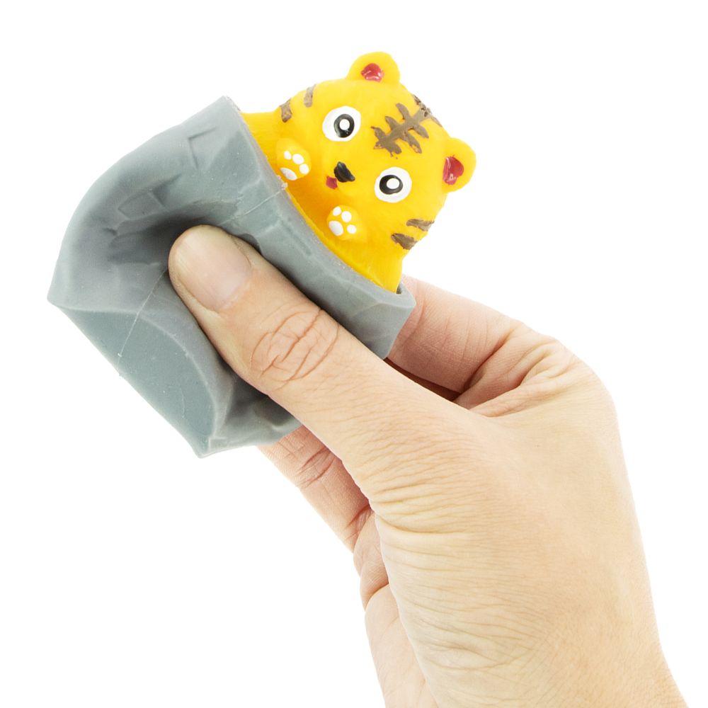 Hand holding a peek-a-book tiger in a gray cave on a white background