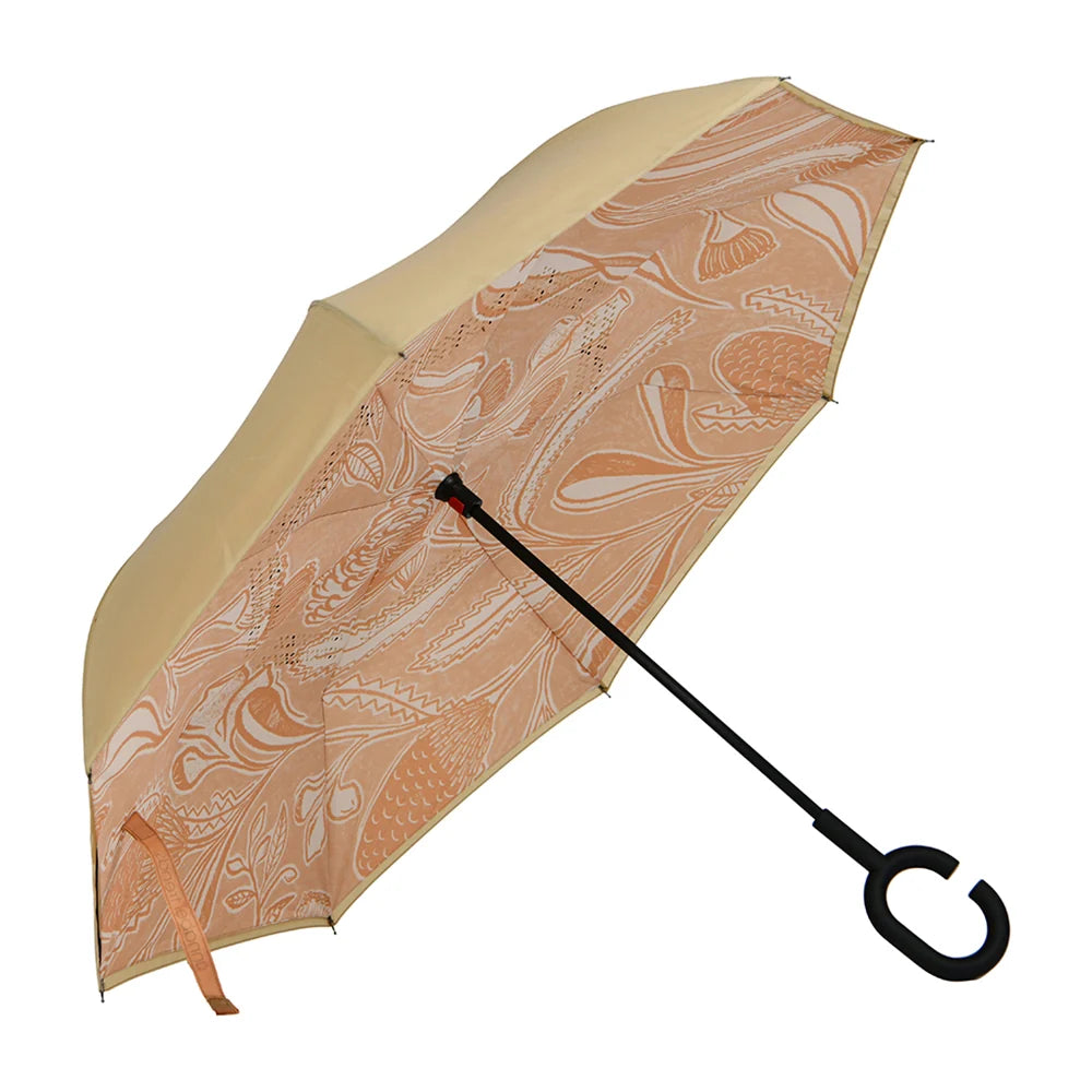 An open Annabel Trends Reverse Umbrella in Trailing Natives Tan pattern against white background.