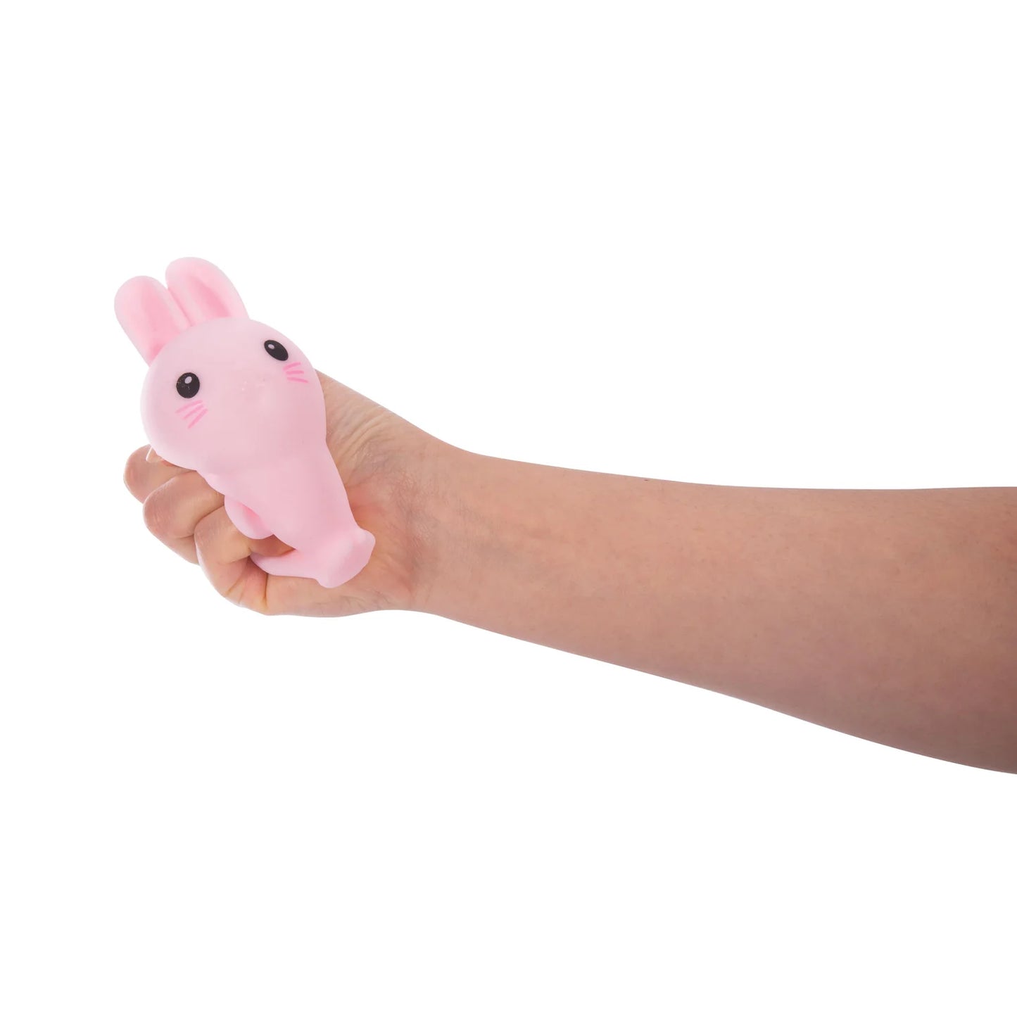 Hand holding a pink bunny-shaped squishy toy from Discovery Zone against a white background