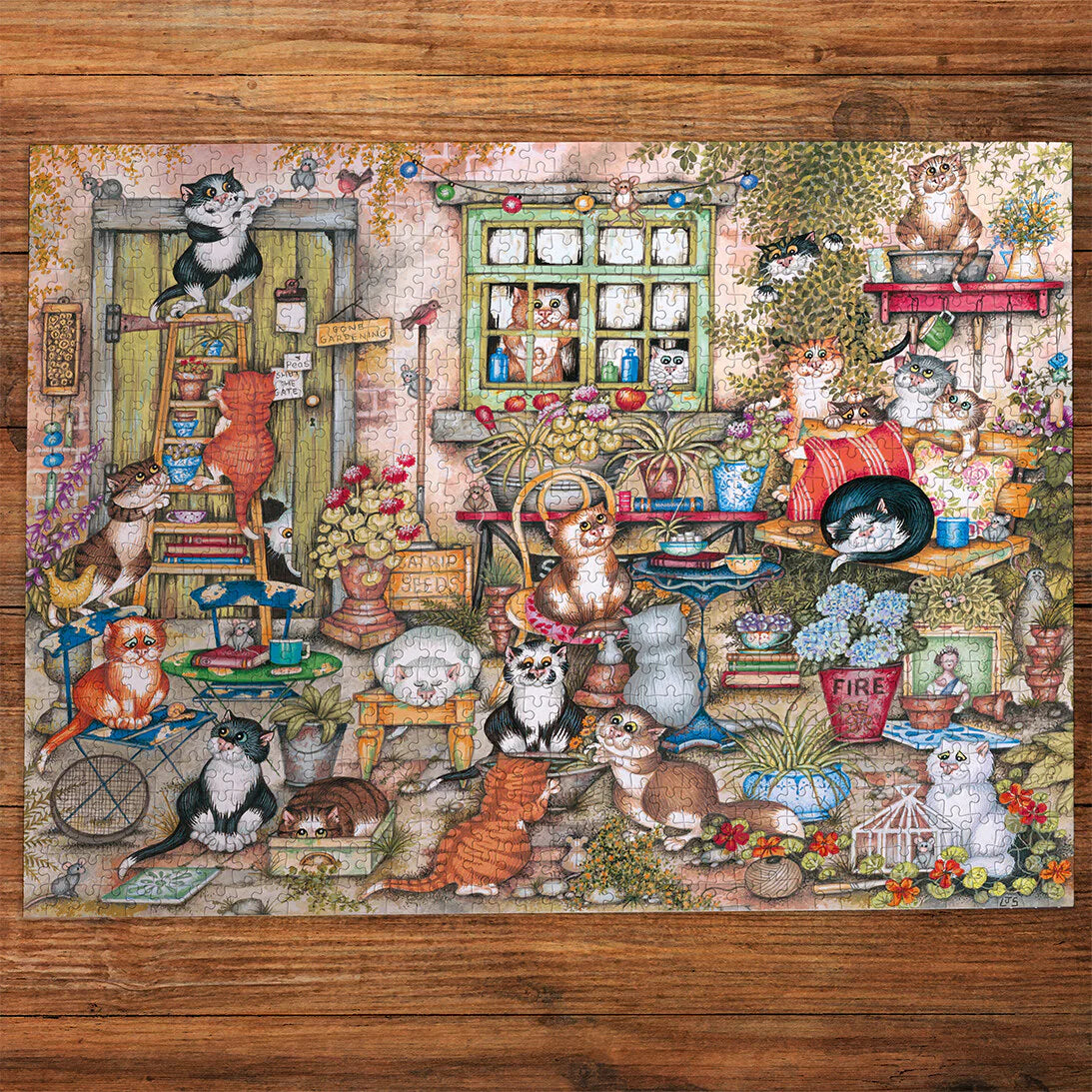 Close-up of Gibsons puzzle pieces featuring cats, mice, plants and rustic courtyard elements