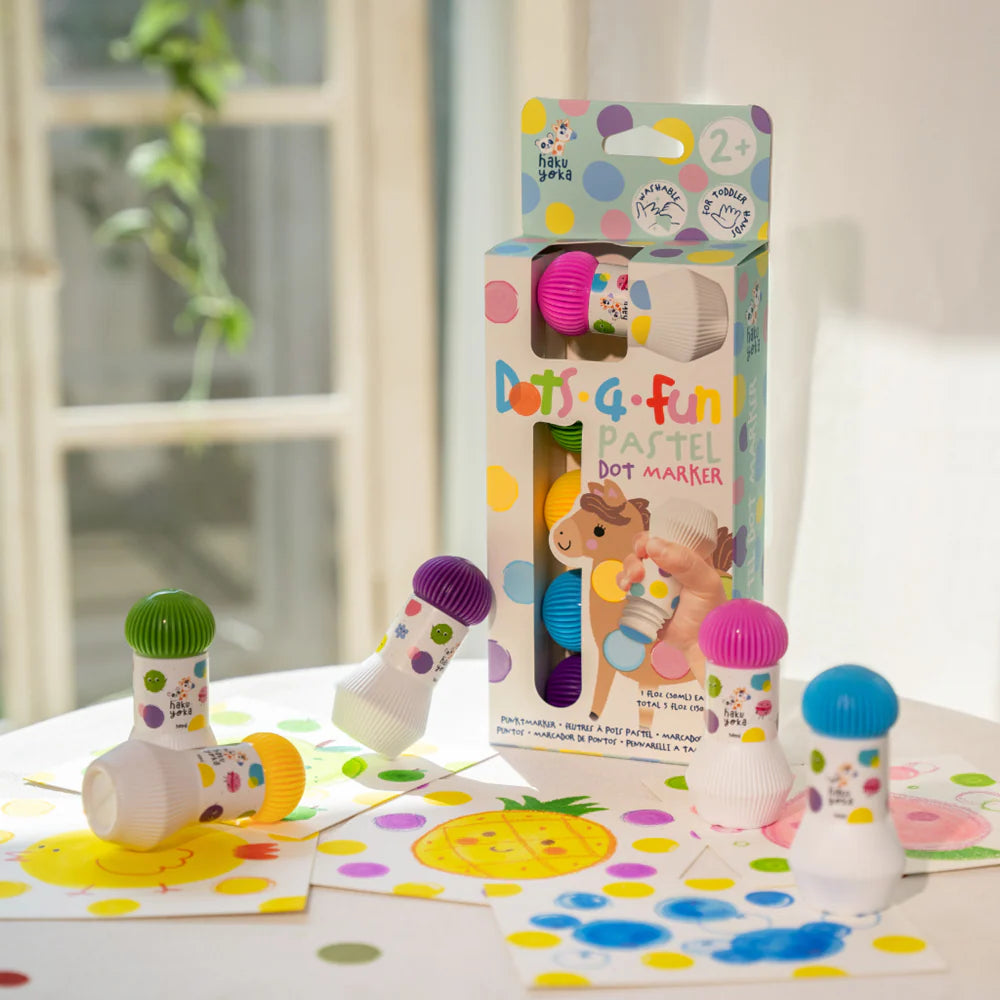 Colorful Haku Yoka Dots 4 Fun Pastel Dot Marker 5pk set with packaging on a table with polka dot patterns.