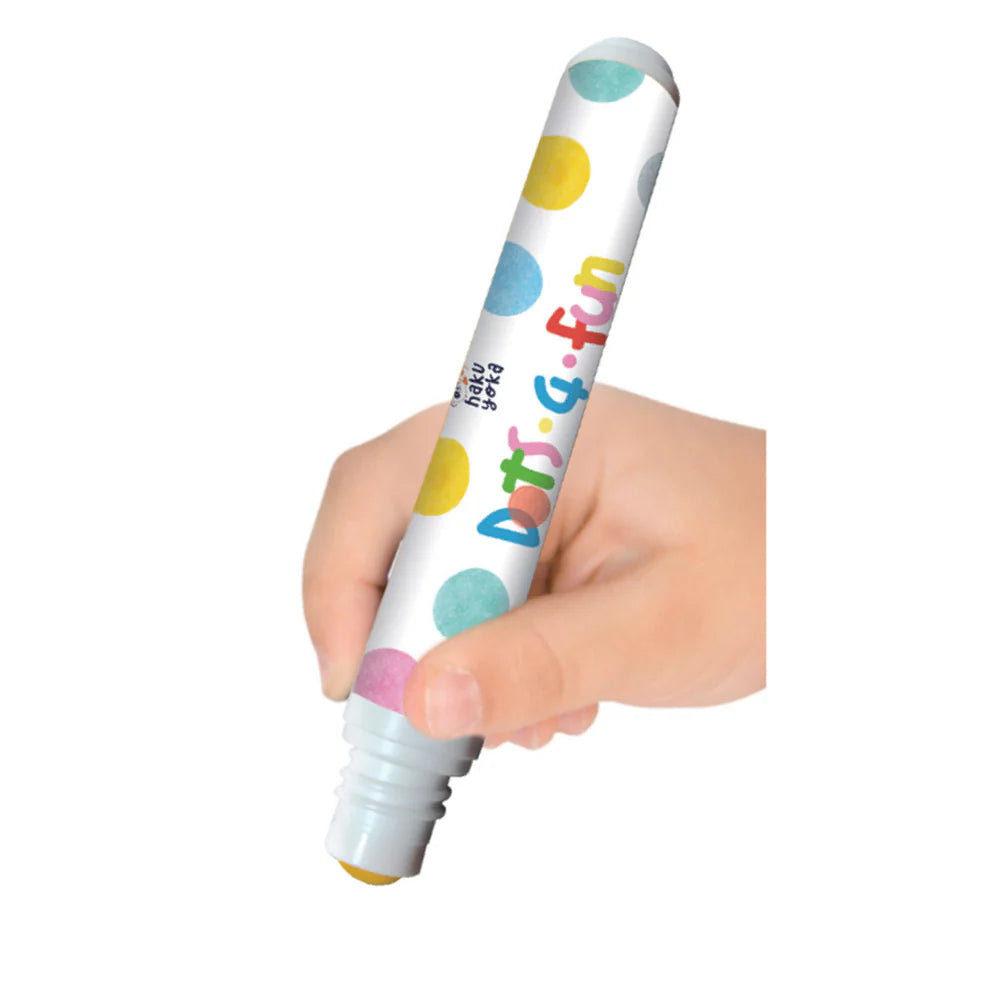 Hand holding a colorful Haku Yoka Dots 4 Fun Pearlescent Dot Marker with polka dot design on a white background