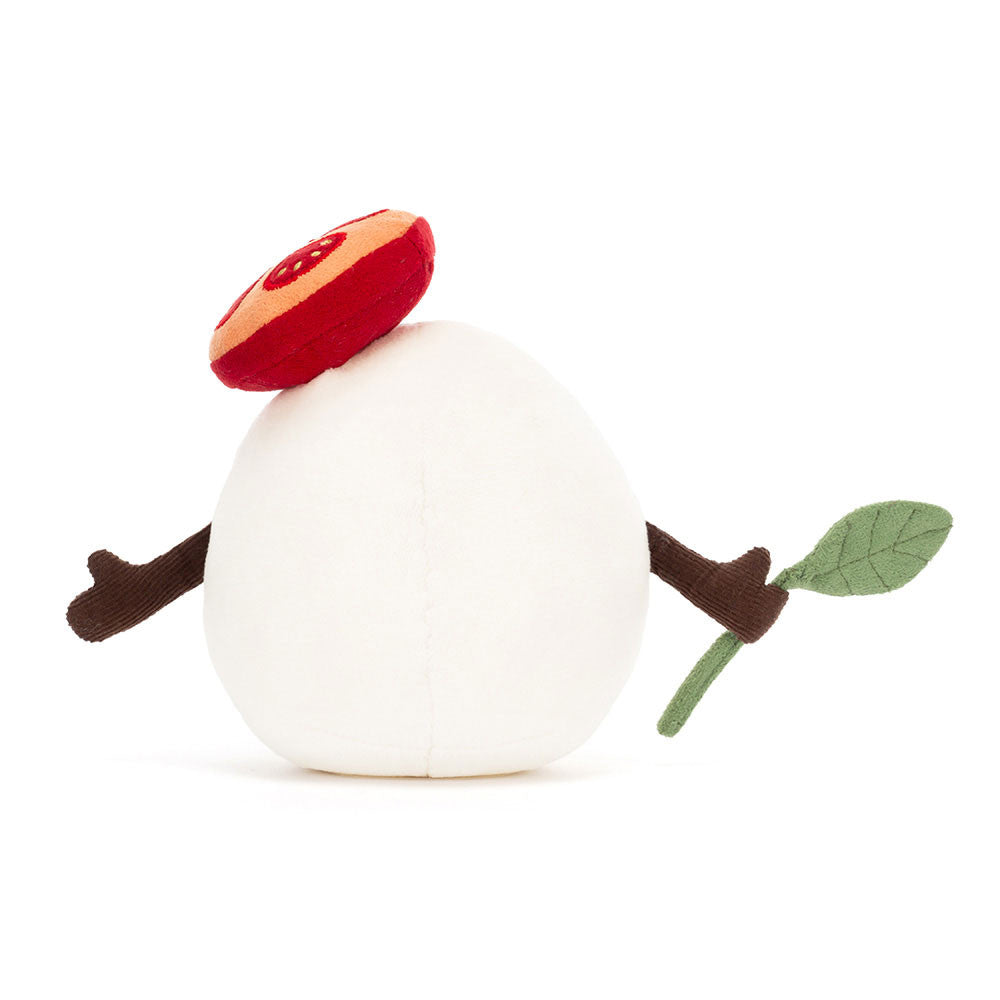 Back view of Jellycat Amuseables Mozzarella Plush toy resembling a block of cheese with a red hat, green leaf, and brown arms on a white background