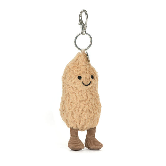 Jellycat Amuseables Peanut Bag Charm Plush keychain in the shape of a peanut with a smiling face on a white background