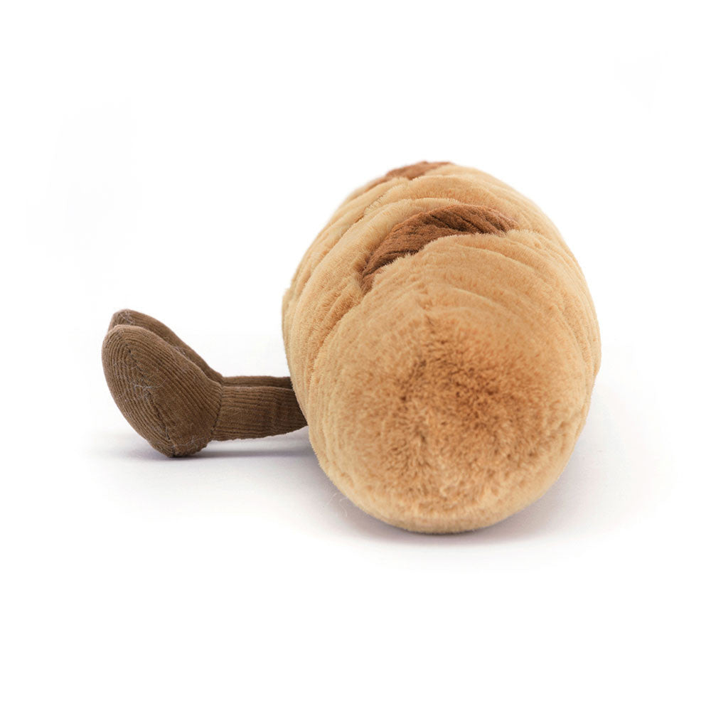 Side view of Jellycat Plush Amuseables Baguette with brown feet on a white background