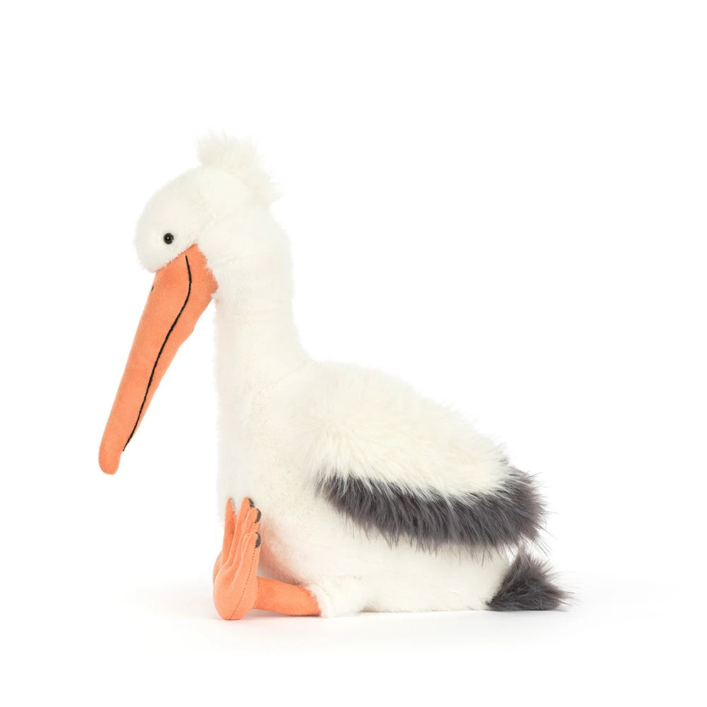 Side view of Jellycat Plush Keli Pelican, with orange feet and orange beak, on a white background