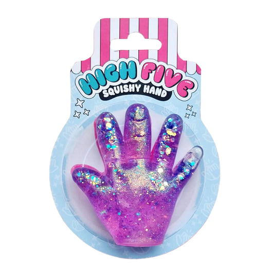 A pink and purple glittery high-five shaped squishy hand toy in its original blister packaging, featuring a pink and white striped header card with the text 'HIGH FIVE SQUISHY HAND'.