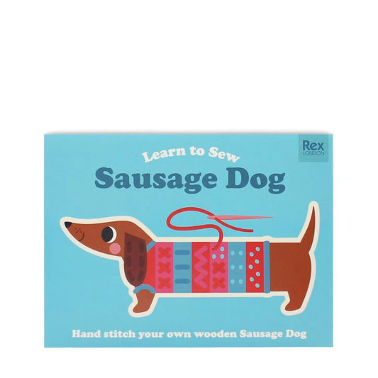 Box cover of 'Learn to Sew Sausage Dog' from rex London with a sausage dog illustration on a blue background.