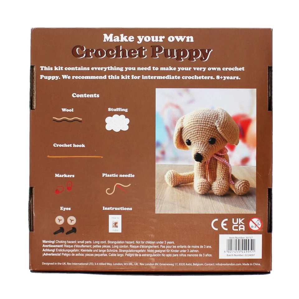 Crochet puppy kit packaging with text and a picture of a crocheted dog.