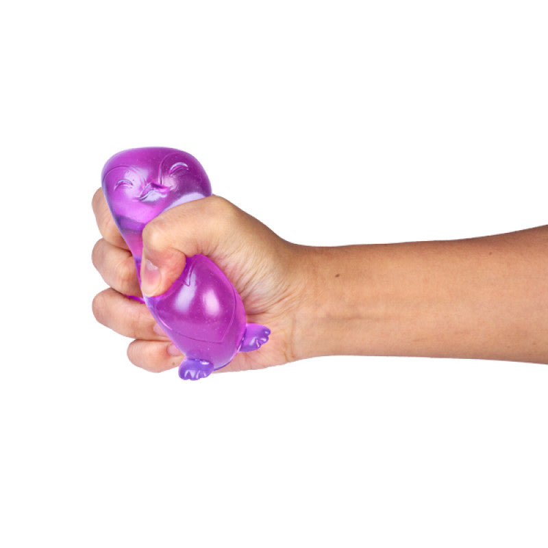 Hand holding a Smoosho's Super Squeeze Penguin against a white background