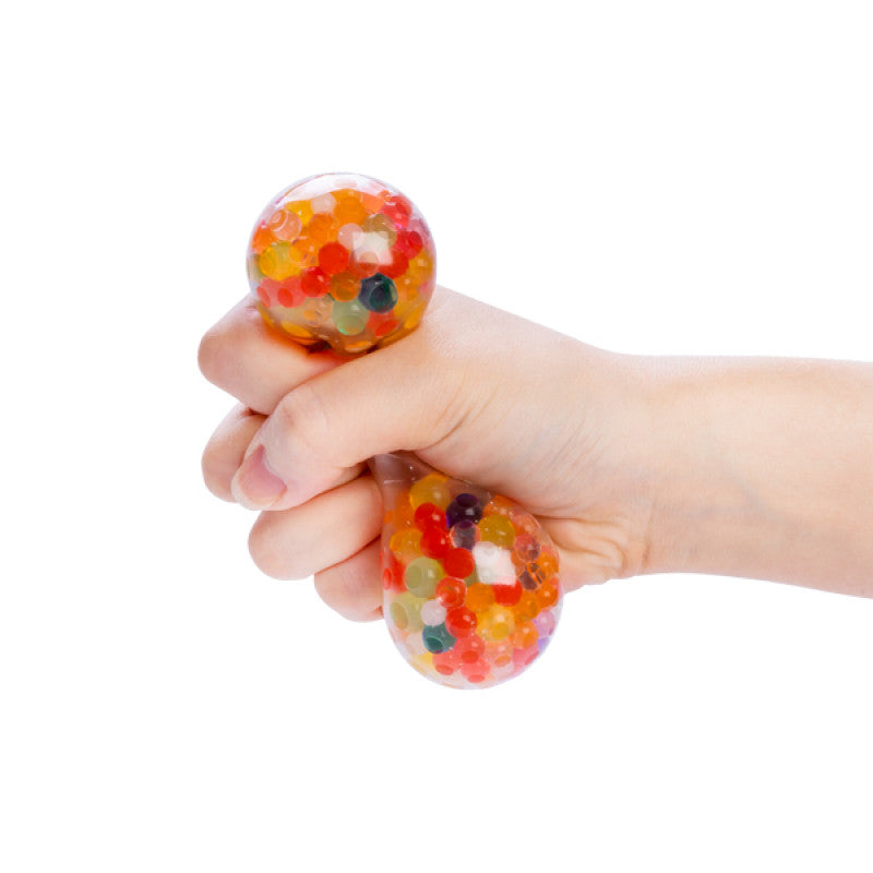 Hand holding a colorful Smooshos Gel Bead Ball stress ball against a white background