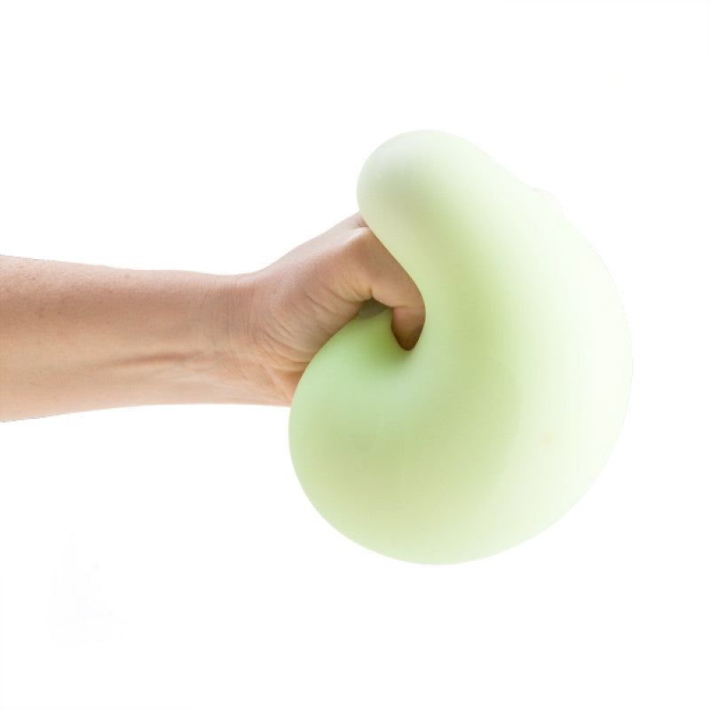 Hand holding a Smooshos Jumbo Glow in the Dark Ball against a white background