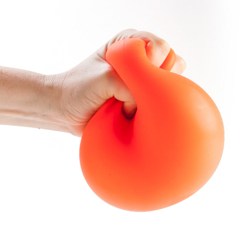 Hand holding an orange Jumbo Smooshos Neon stress ball against a white background