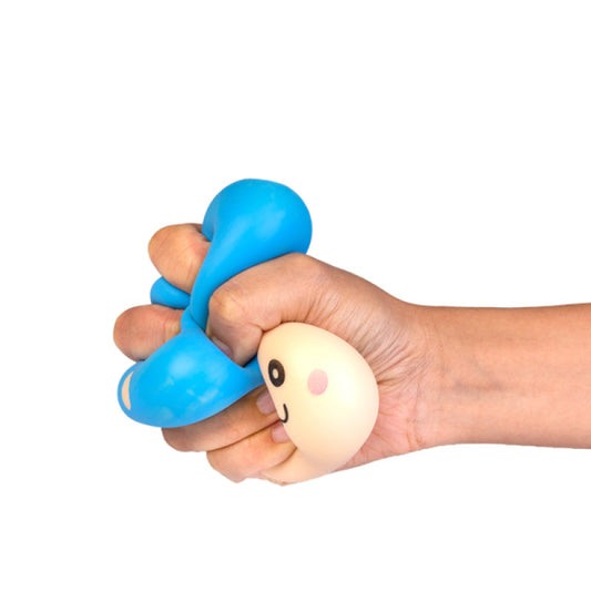 Hand holding a blue and beige Smooshos Squishy Mushrooml with a face on a white background