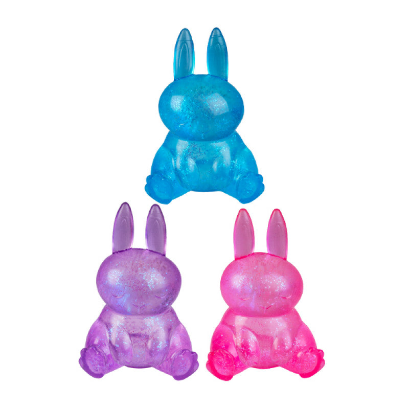 Three colorful Smooshos Super Squeeze Glow In The Dark Bunny on a white background