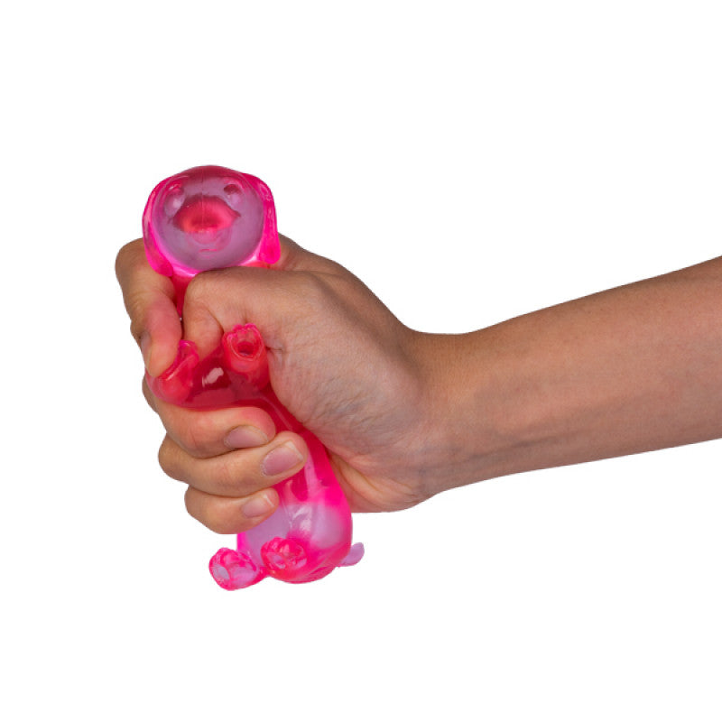 Hand holding a Smooshos Super Squeeze Glow in the Dark Dachshund against a white background