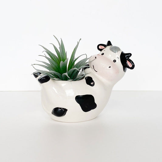 Reclining cow planter from Urban Products shown with plant