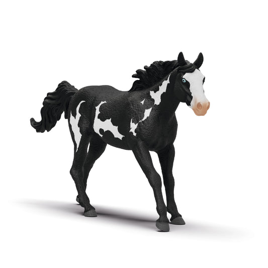 Black and white Schleich Paint Horse Gelding, against a white background.