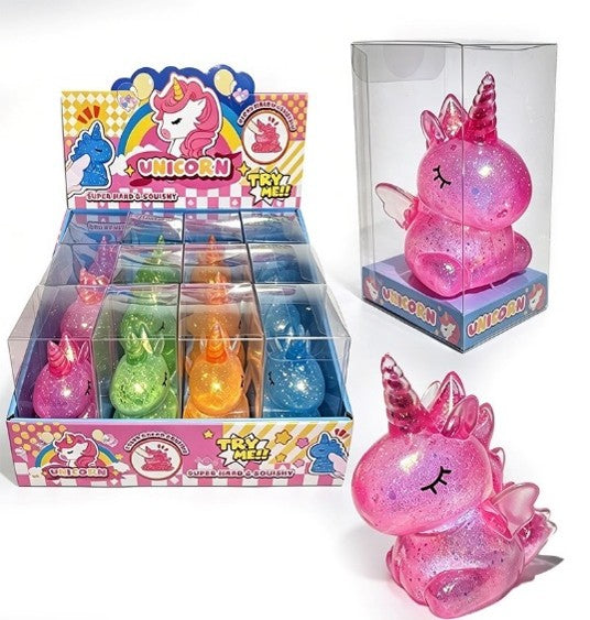 A pink glittery unicorn squishy toy shown with its retail display box and individual clear packaging on a white background.