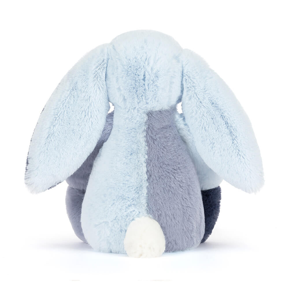 Geometric light and dark blue bunny toy against a white background, back view