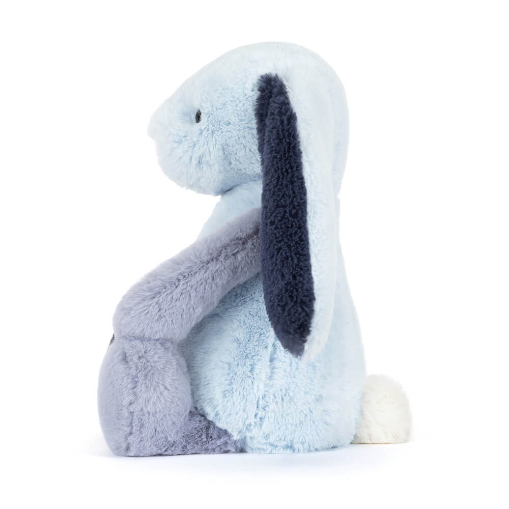 Geometric light and dark blue bunny toy against a white background, side view